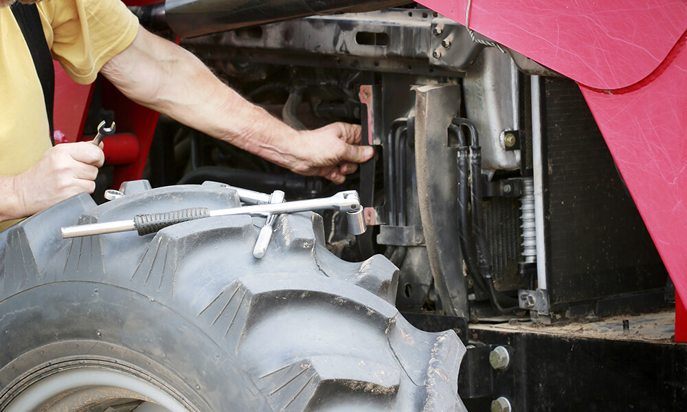 Man repairing tractor